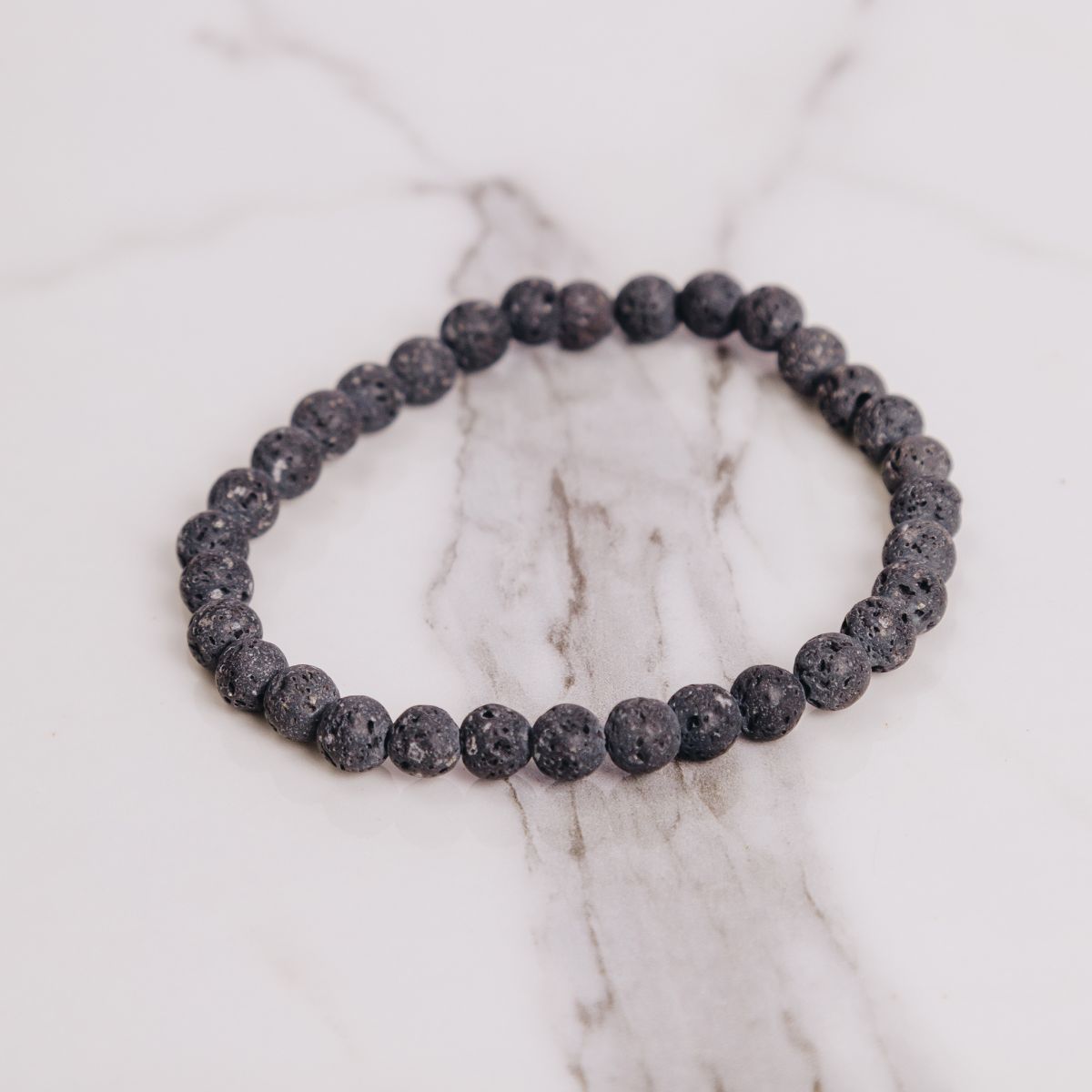 lava stone bracelet on marble background